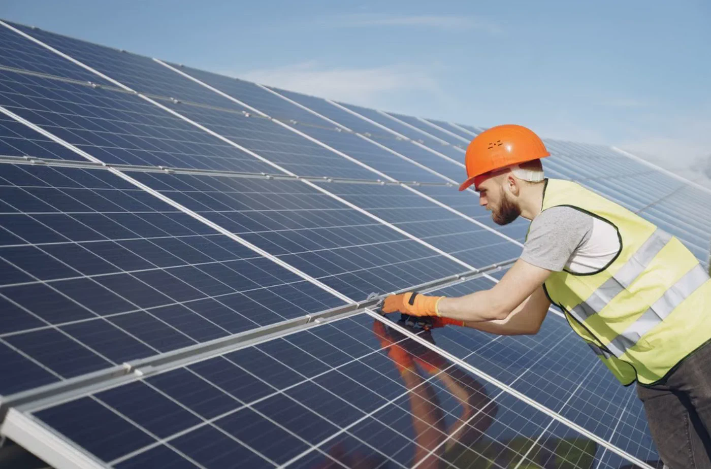 Tailored Energy installer fitting solar panels on a commercial roof in Auckland